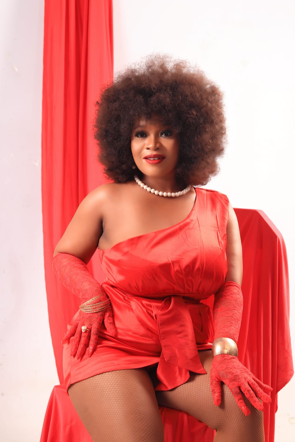 Siziwe Ngema in a red dress with afro hair, performing energy for the Zola Budd single